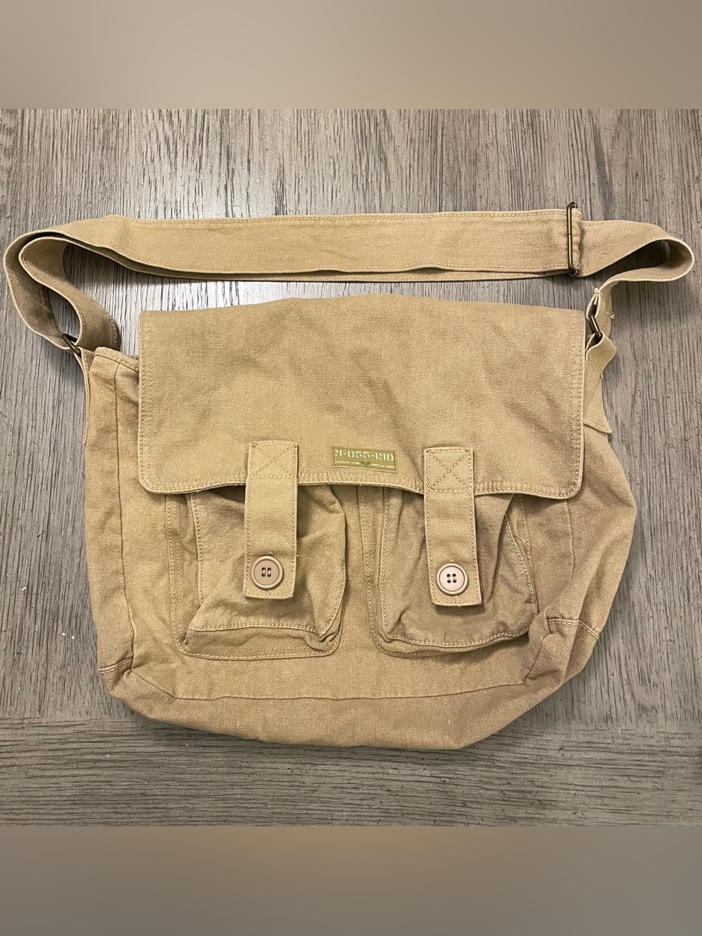 Canvas messenger bag, fold-over flap, 2 front cargo pockets w/ velcro closure.
